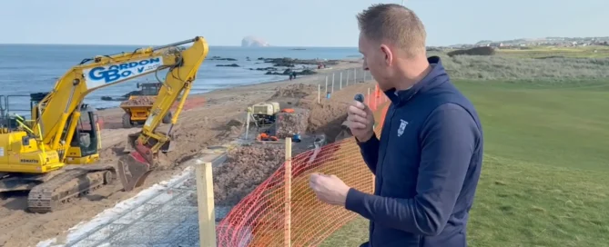 Stuart Bayne filming an update beside coastal defence works on North Berwick's shoreline, with Bass Rock visible offshore